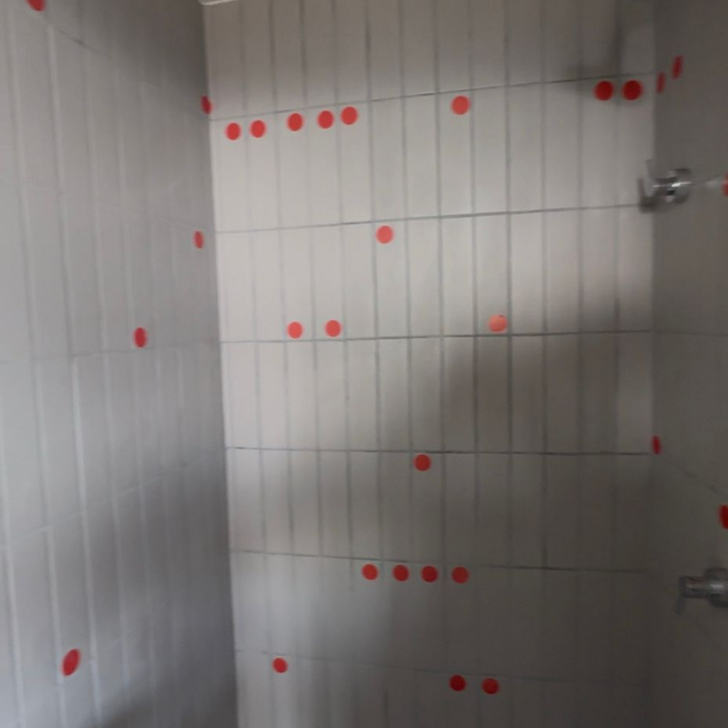 Vistoria de entrega no RJ identificando cerâmica com desnível e falha de assentamento em banheiro.